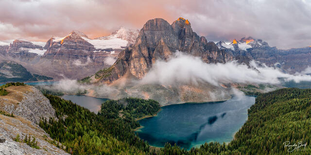 panoramic photo of Sunburst Peak and Mount Assiniboine from the Nub at sunrise.