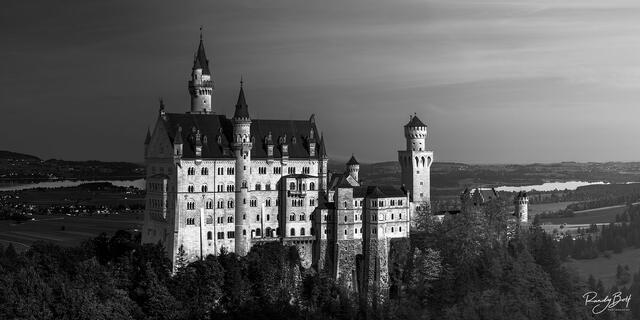 black and white panorama photograph of the neuschwanstein castle