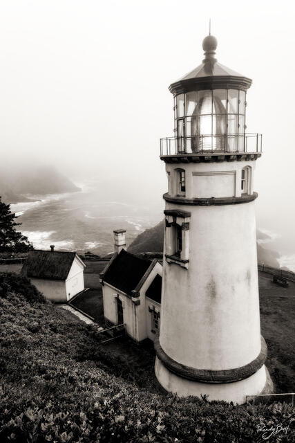 black and white vertical photograph of the Haceta Head Lighthouse with coastal fog.