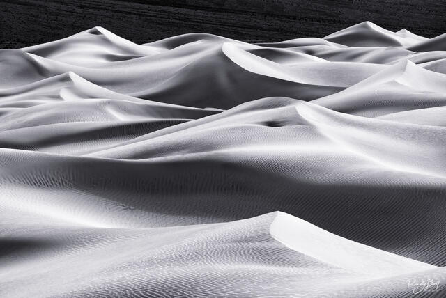 a black and white photograph of mesquite dunes in Death Valley national park