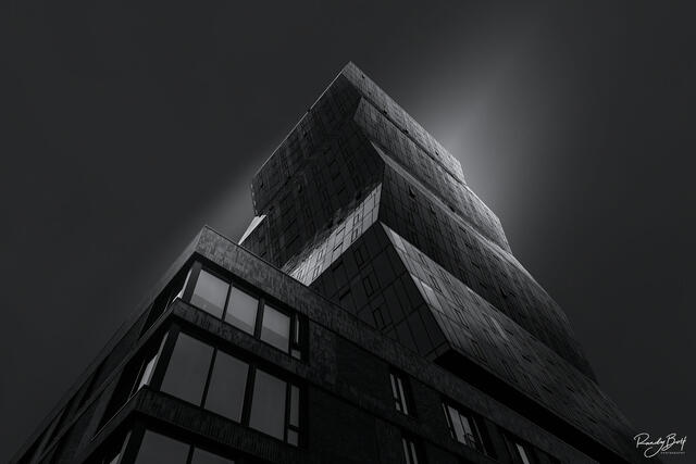 A dark black and white image of a new building in downtown Seattle