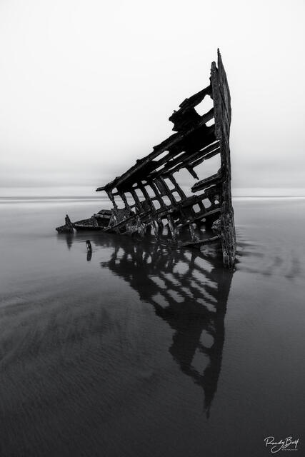 Black and white photo of the Peter Iredale shipwreck.