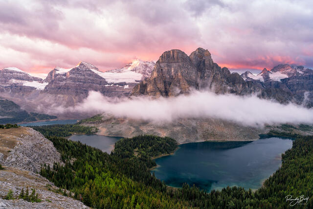 Sunburst peak and Mount Assiniboine at sunrise after a night of stormy weather.
