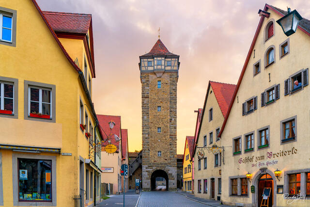 sun rising behind a watchtower in Rothenburg ob der tauber, Germany.
