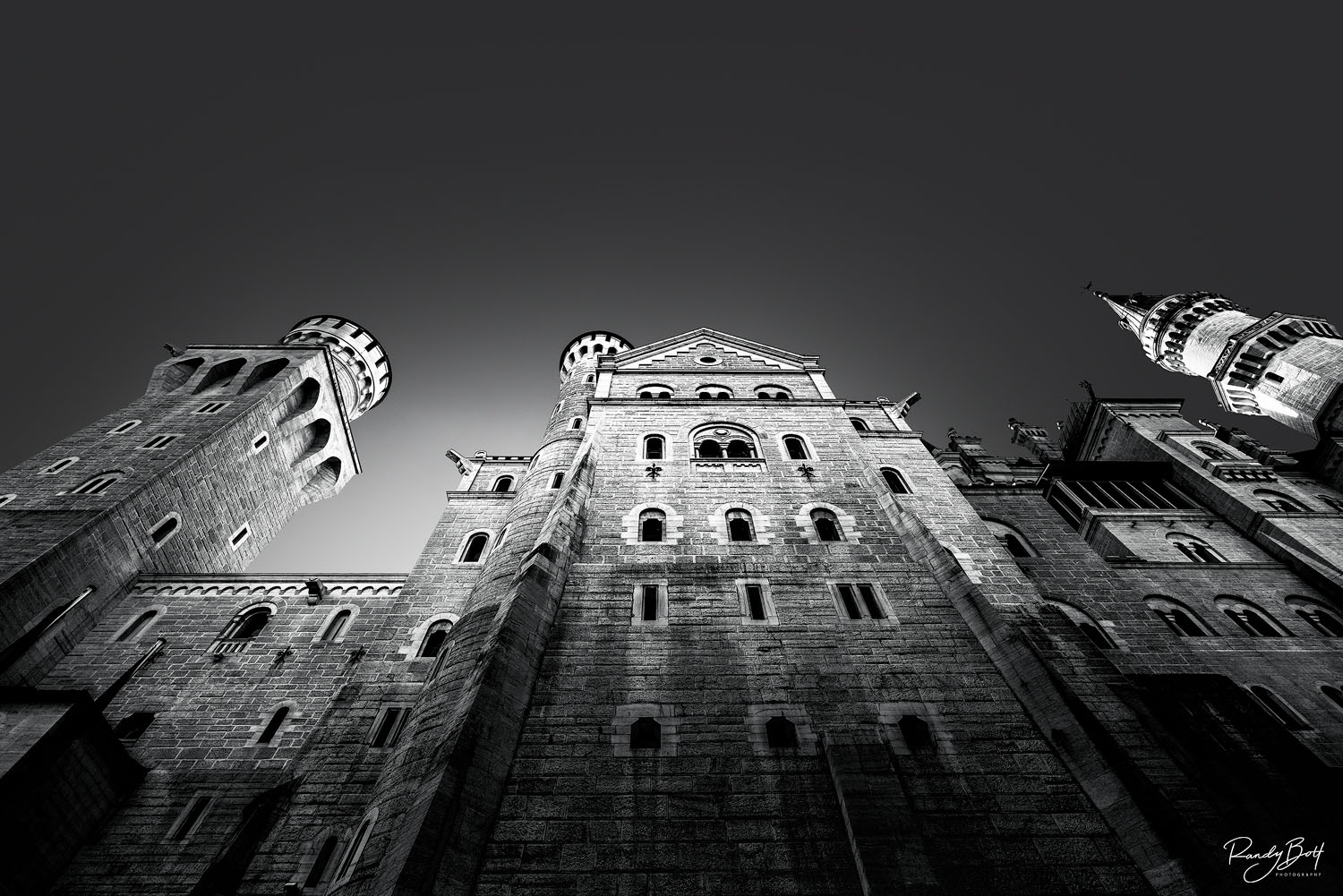 black and white photograph of the Neuschwanstien Castle looking towards the sky