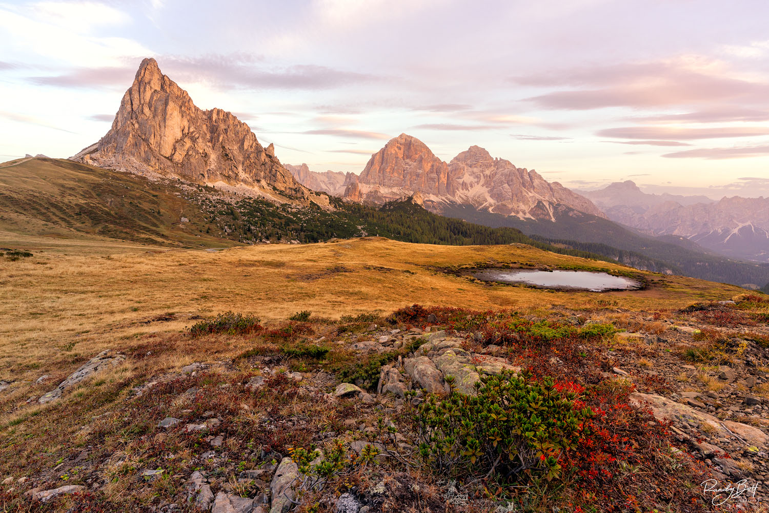 sunrise at passo Giau in the Italian dolomites with the reflection pond.